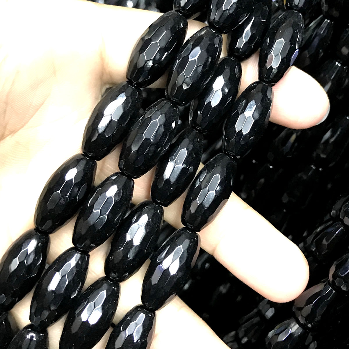 CAG765 Black Agate Beads Faceted Rice 10x20mm 15" Strand