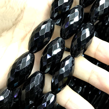 CAG769 Black Agate Beads Faceted Rice 15x30mm 15" Strand