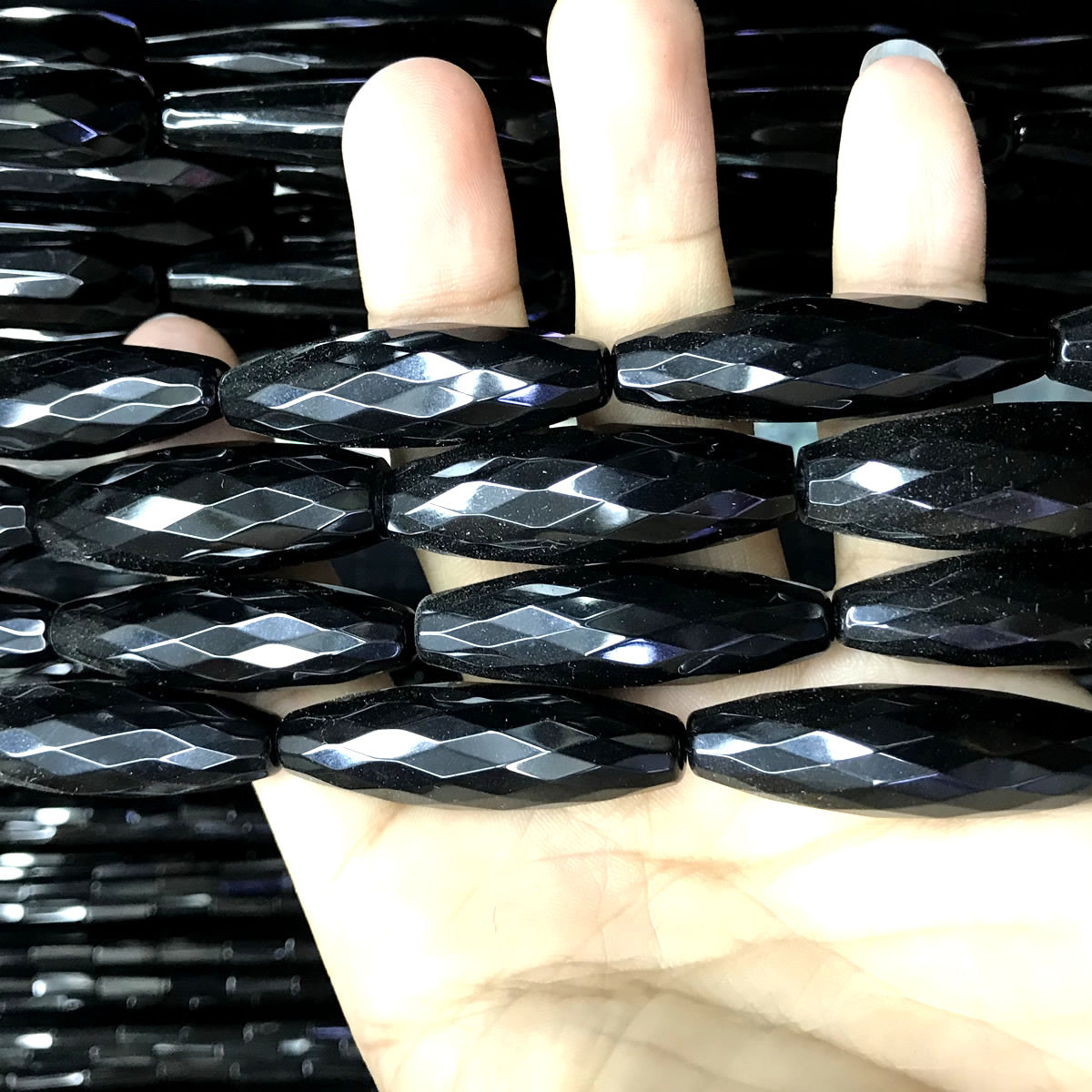 CAG770 Black Agate Beads Faceted Rice 12x50mm 15" Strand