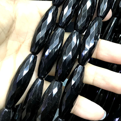 CAG770 Black Agate Beads Faceted Rice 12x50mm 15" Strand