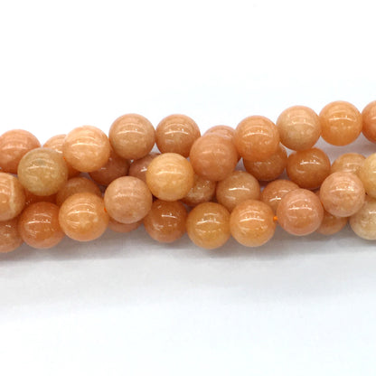 CCA16 Peach Calcite Beads Smooth Round 14mm 15.5" Strand